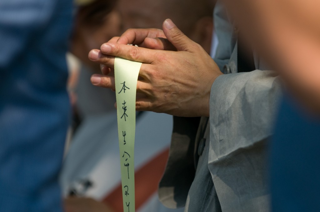 a buddhist monk holds his ribbon of hope